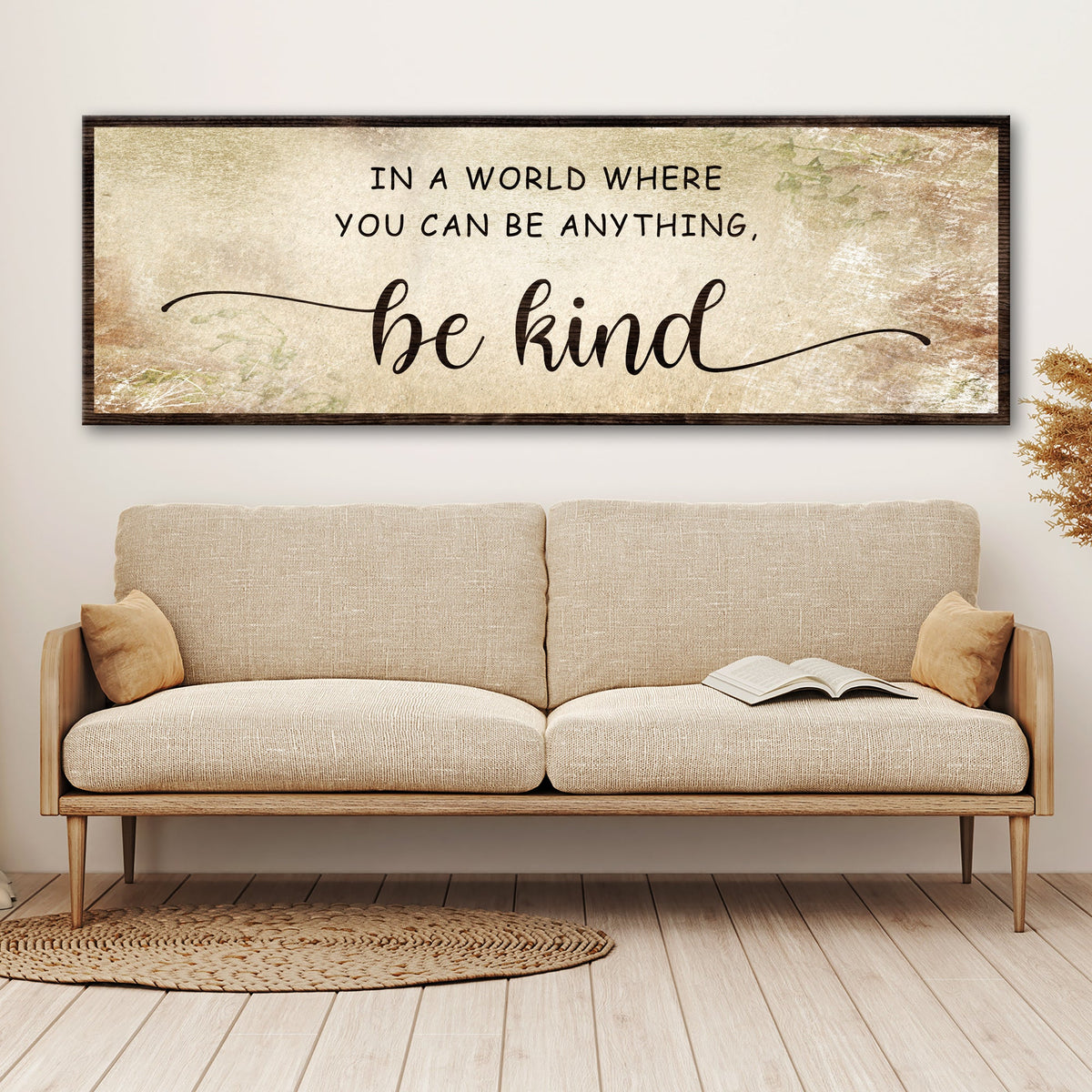 Be Kind canvas sign in the beige floral style above a beige sofa