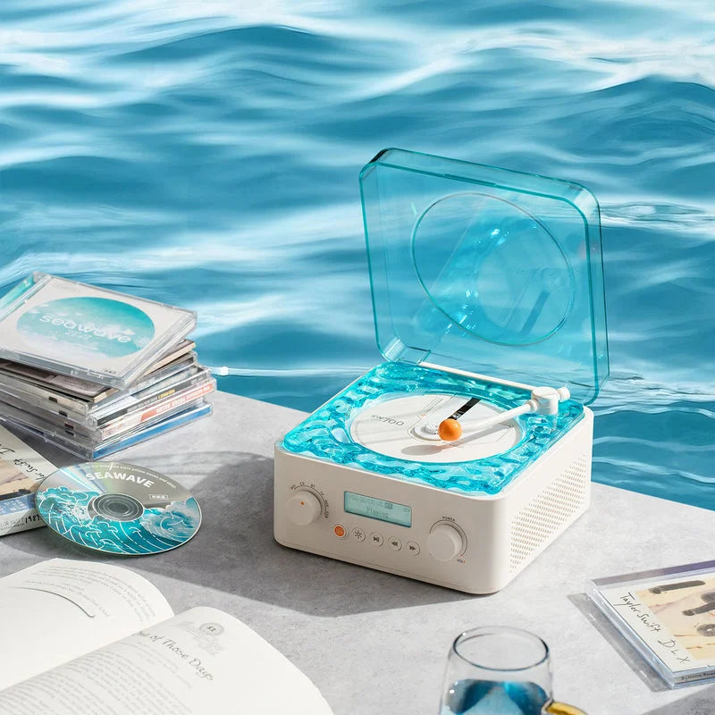 Vintage-style Bluetooth speaker with water wave screen and CD player surrounded by vinyl records and magazines