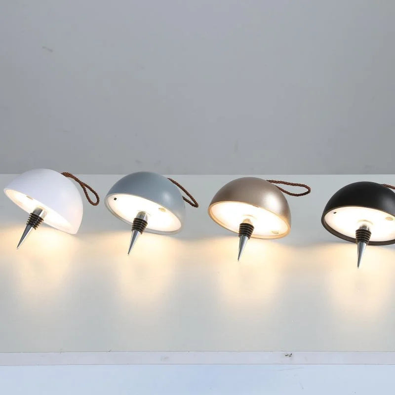 Wine bottle lamp collection showing white, gray, gold and black dome shades illuminated
