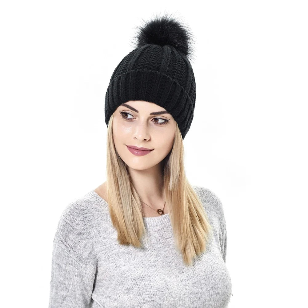 Woman using Black satin lined winter hat with matching faux fur pom pom