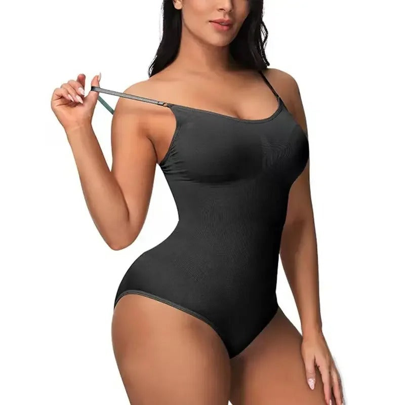 Woman wearing a black tummy control bodysuit holding on a white background