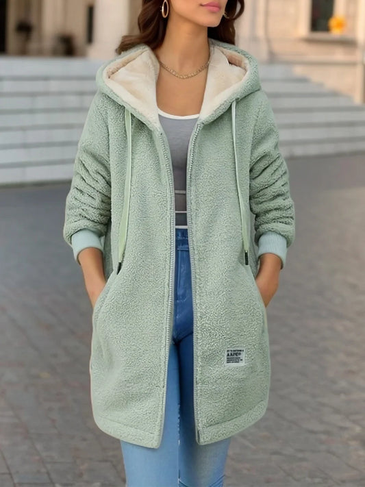 Women’s cozy fleece-lined hooded jacket in light green, styled for a warm and casual everyday look
