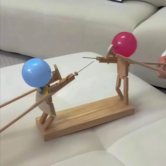 Wooden balloon battle game with two bamboo fighters dueling on desk