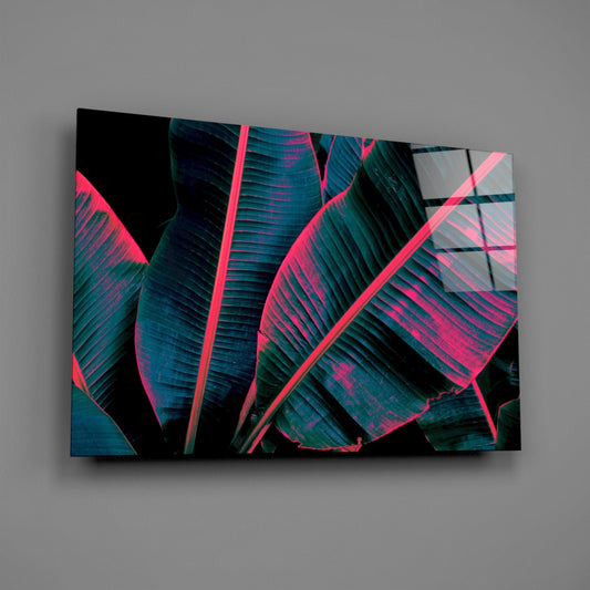 Neon banana leaf glass wall art on a gray wall, light reflecting off the glossy front