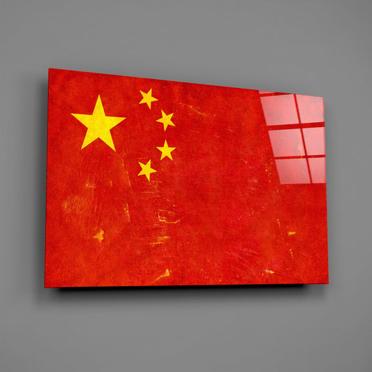Weathered China flag glass wall art on a gray wall with a window reflection across the glossy glass