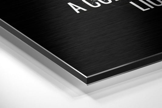 Never give up lion brushed aluminum panel corner close-up showing the brushed metal grain