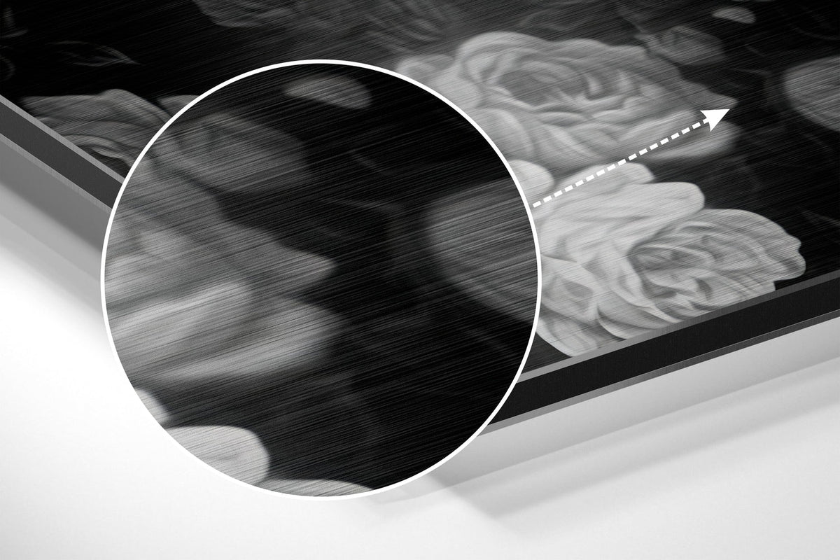 Magnified detail of the brushed metal grain showing through the black and white skull with roses print