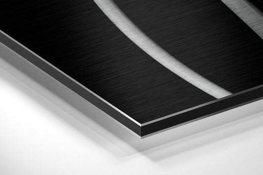 Black and white tulips brushed aluminum panel corner close-up showing the brushed metal grain