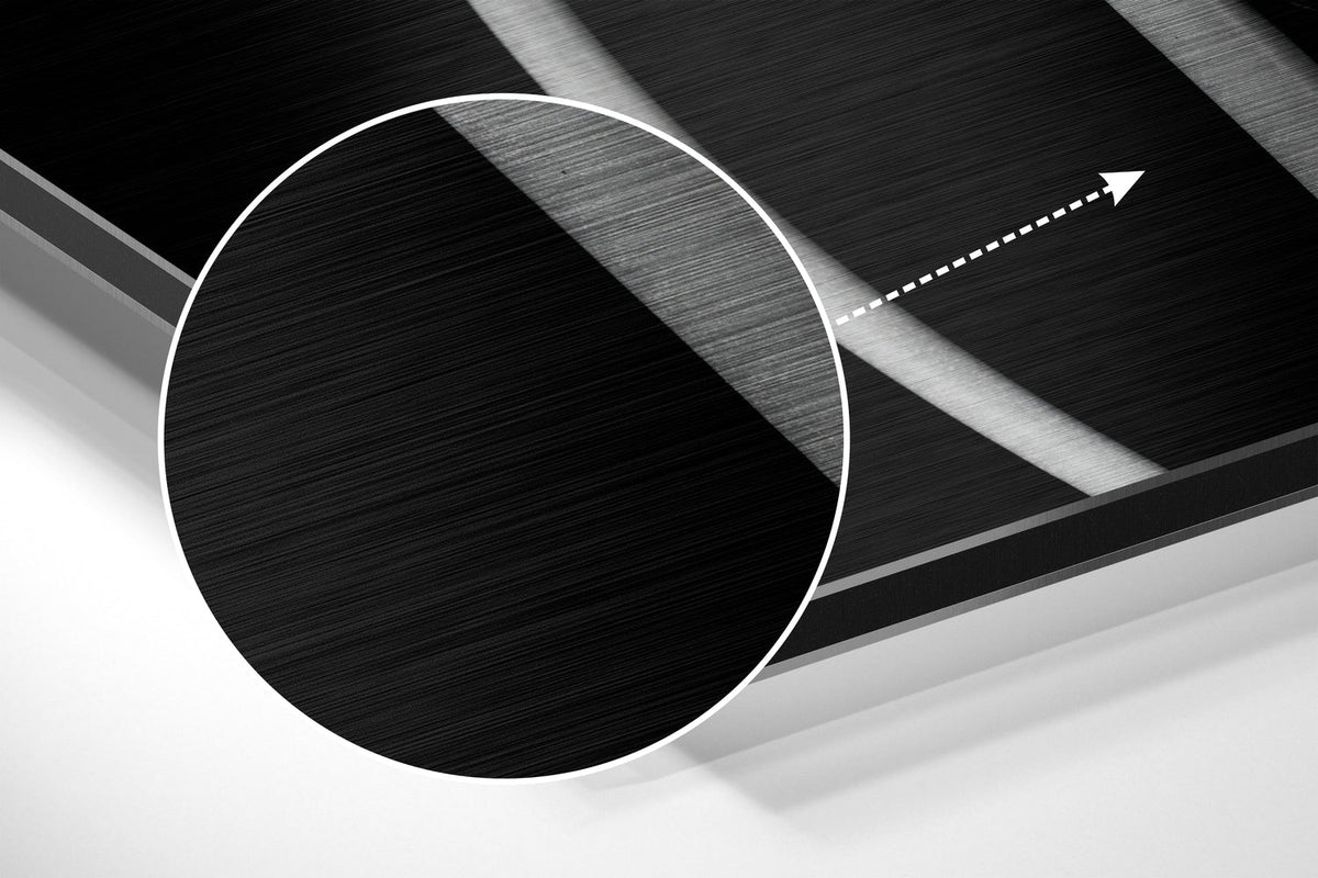 Magnified detail of the brushed metal grain showing through the black and white tulips print