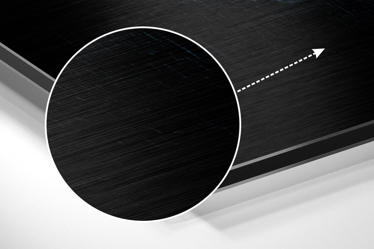 Magnified detail of the brushed metal grain showing through the teal neon lettering print