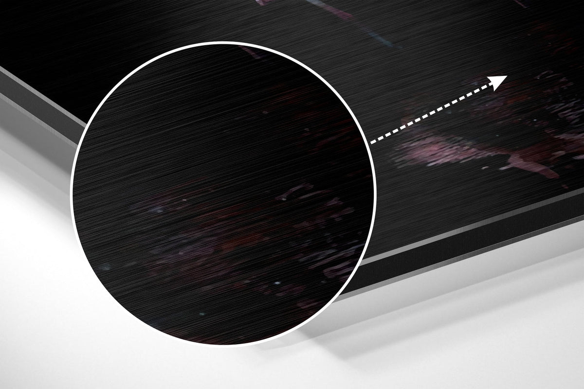 Magnified detail of the brushed metal grain showing through the pink flamingo flock on black print