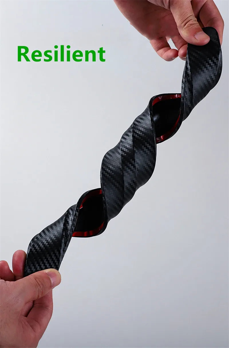 Flexible PVC carbon-fiber look bumper strip being twisted to show resilience.