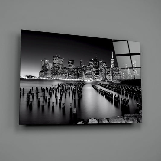 Black and white Manhattan pier glass wall art angled against a plain gray backdrop