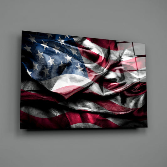 Dark silky American flag glass wall art on a gray wall, light catching the glossy glass surface