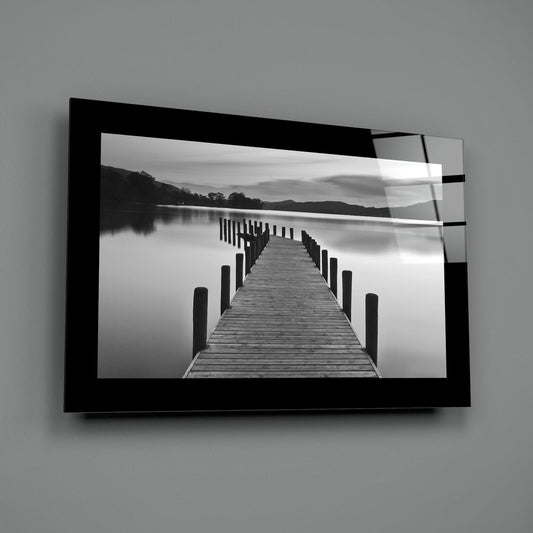 Black and white lake pier glass wall art on a gray wall