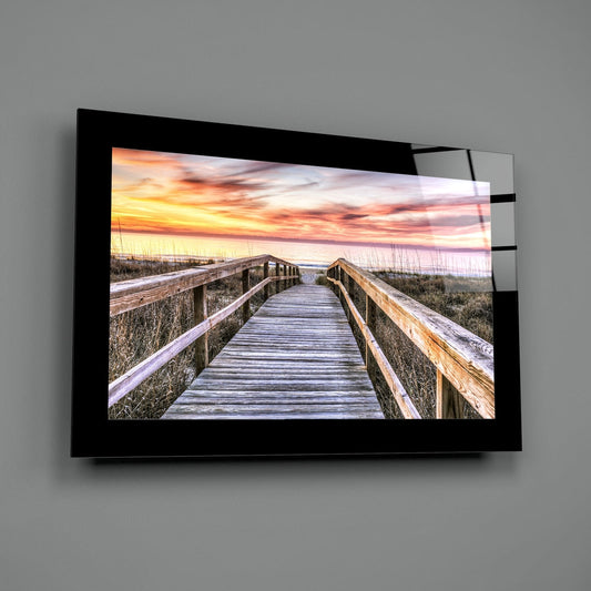 Beach boardwalk through dunes at sunset glass wall art on a gray wall