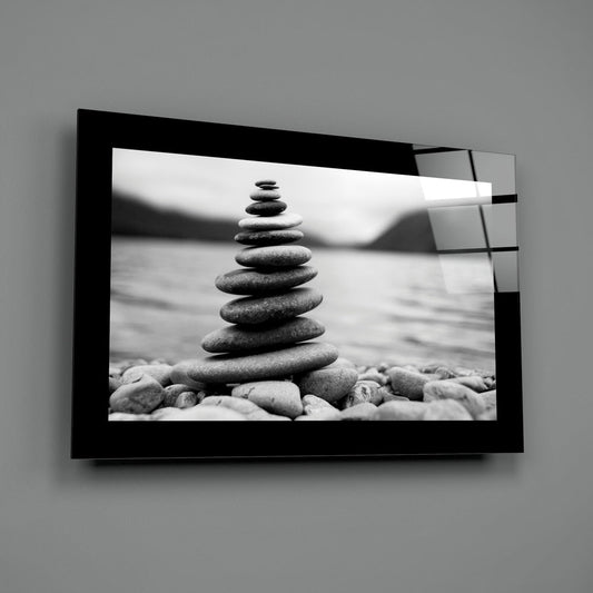 Black and white zen stone cairn glass wall art on a gray wall