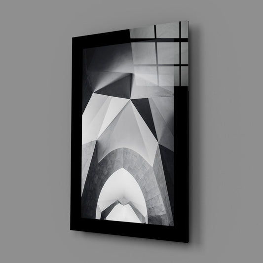 Black and white pointed arches tempered glass print angled against a gray wall