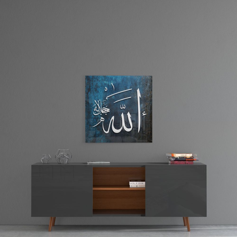 Dark teal Allah calligraphy glass wall art above a gray sideboard with a wooden center shelf