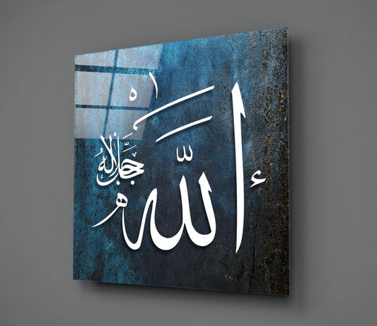 Dark teal Allah calligraphy glass wall art hanging on a plain gray wall, seen at an angle