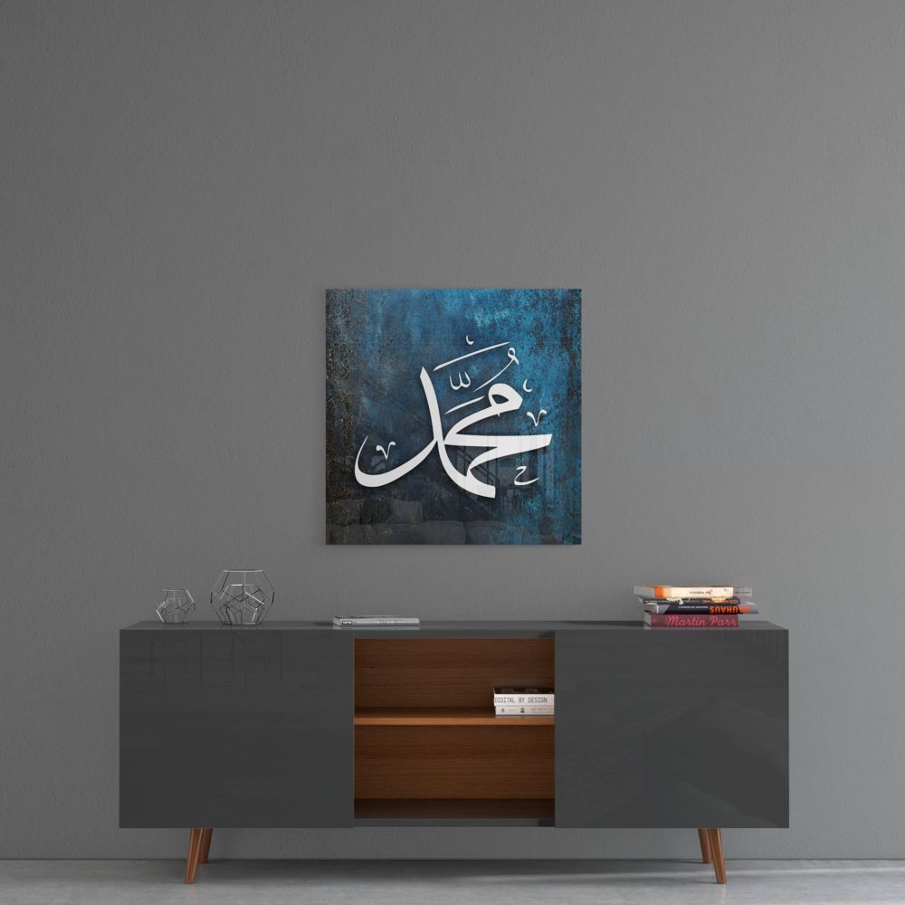 Dark teal Muhammad calligraphy glass wall art above a gray sideboard with a wooden center shelf