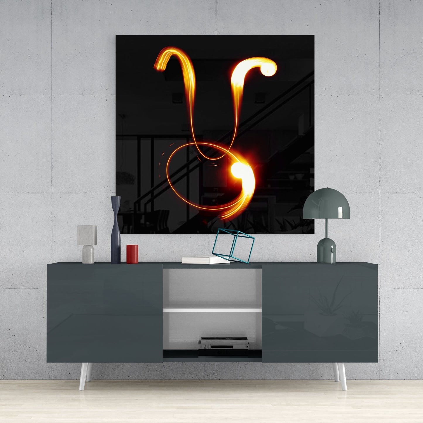 Taurus light trail glass wall art above a dark gray sideboard with a dome lamp and a teal wire cube