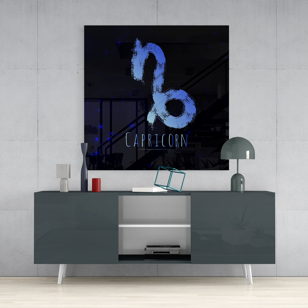 Blue Capricorn brushstroke glass wall art above a dark gray sideboard with a dome lamp and a teal wire cube