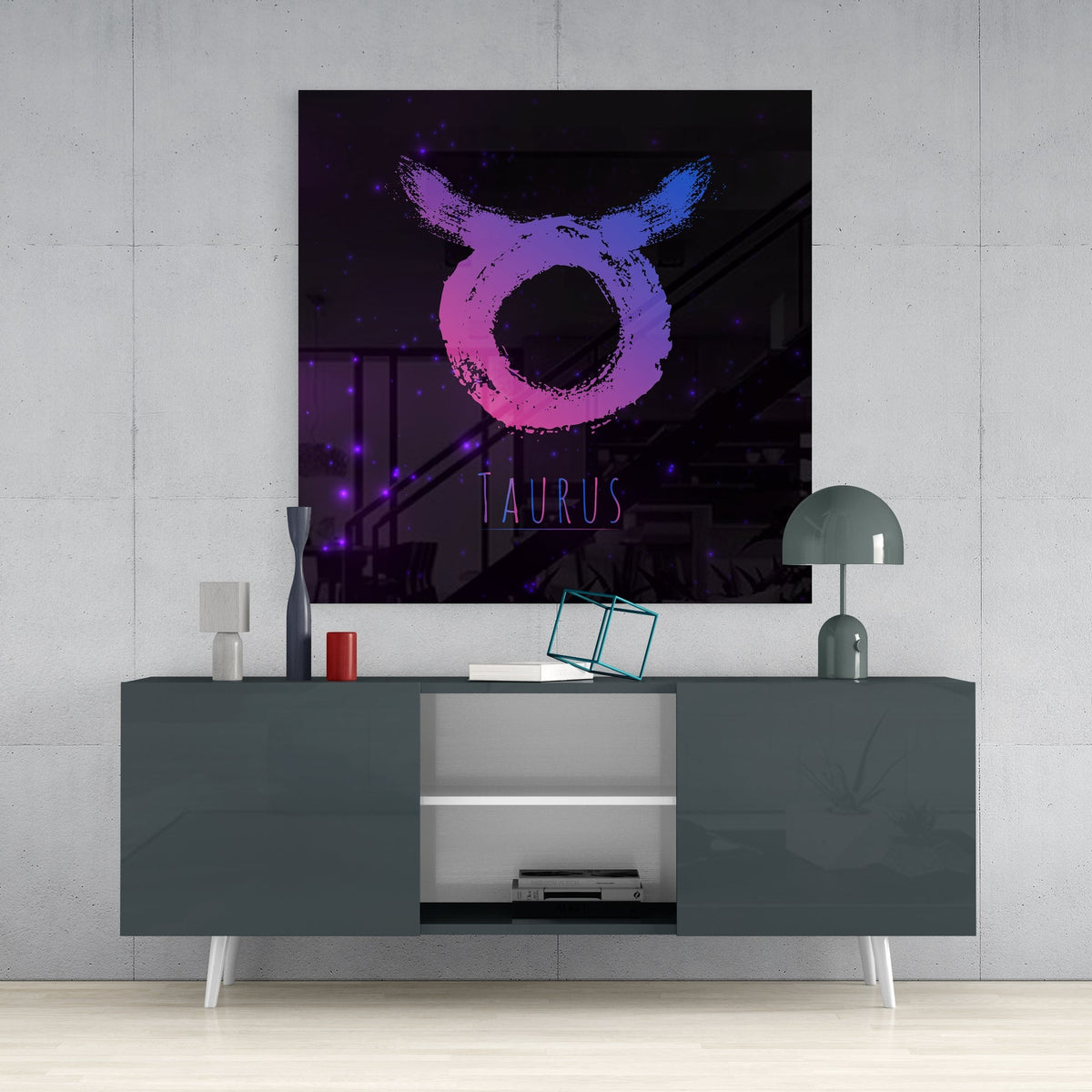 Pink and Blue Taurus brushstroke glass wall art above a dark gray sideboard with a dome lamp and a teal wire cube