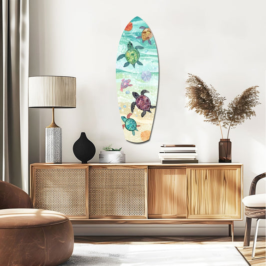 Baby sea turtles surfboard glass wall art above a rattan sideboard with a table lamp and pampas grass