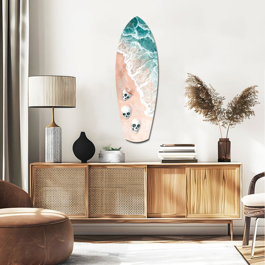 Pink beach and skulls surfboard glass wall art above a rattan sideboard with a table lamp and pampas grass