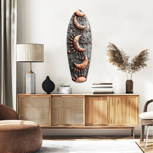 Crescent moons surfboard glass wall art above a rattan sideboard with a table lamp and pampas grass