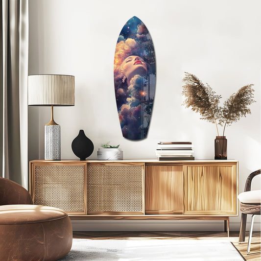 Cosmic face surfboard glass wall art above a rattan sideboard with a table lamp and pampas grass