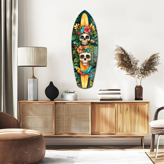 Floral skulls and macaw surfboard glass wall art above a rattan sideboard with a table lamp and pampas grass