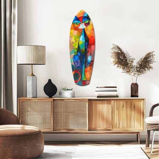 Geometric cat surfboard glass wall art above a rattan sideboard with a table lamp and pampas grass