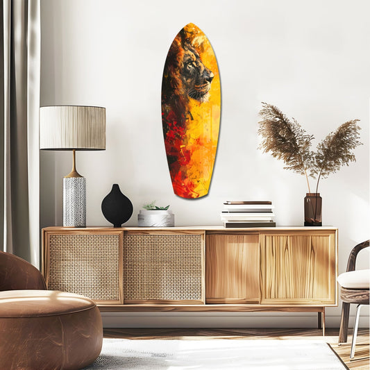 Lion on orange surfboard glass wall art above a rattan sideboard with a table lamp and pampas grass
