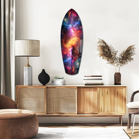 Pink nebula surfboard glass wall art above a rattan sideboard with a lamp and pampas grass