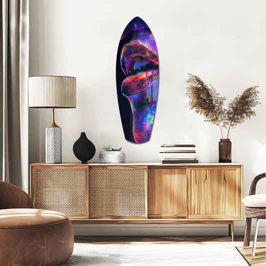 Glossy red lips profile surfboard glass wall art above a rattan sideboard with a table lamp and pampas grass