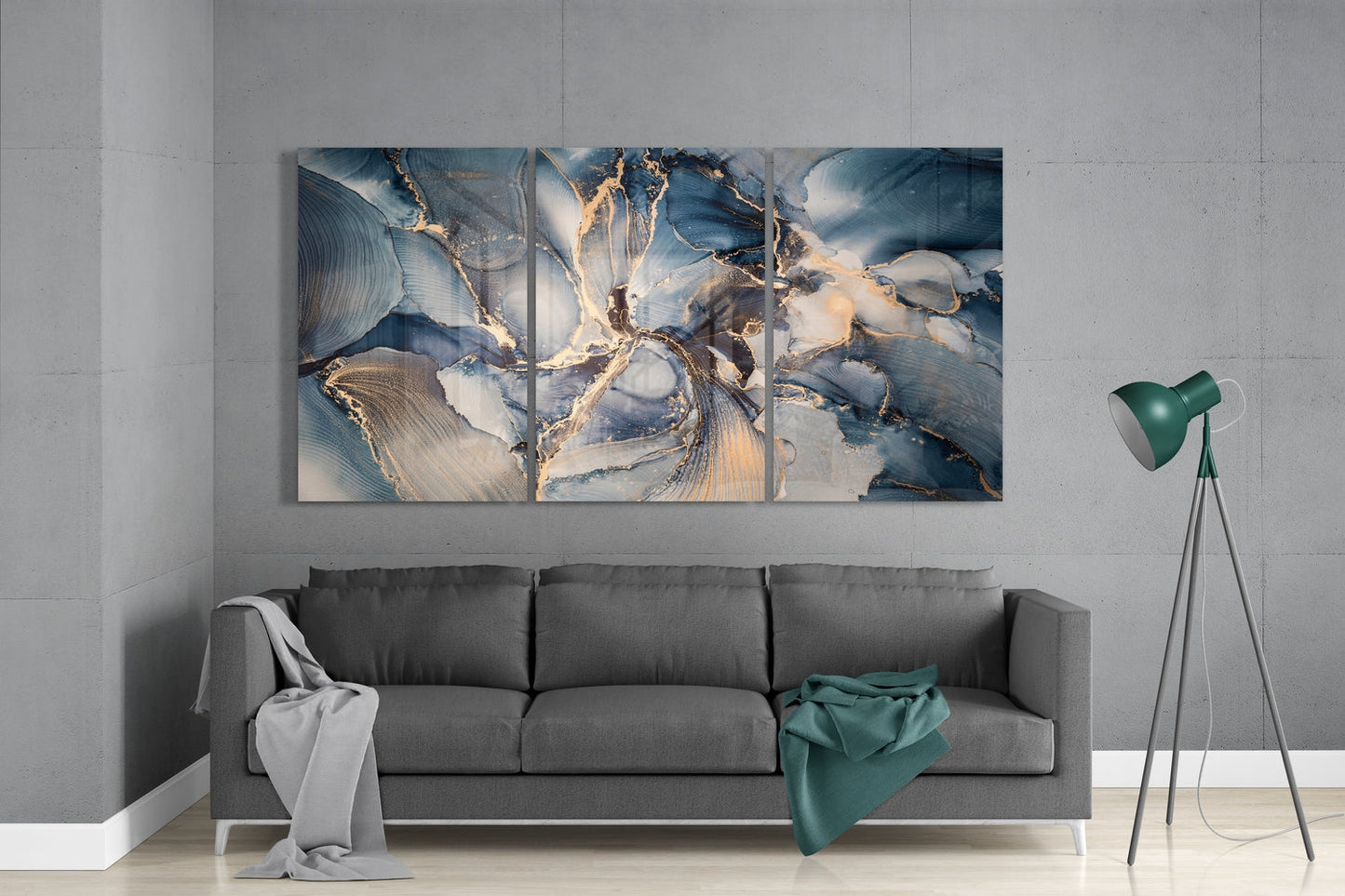 Navy and gold marble swirl glass wall art set above a gray sofa beside a tripod floor lamp