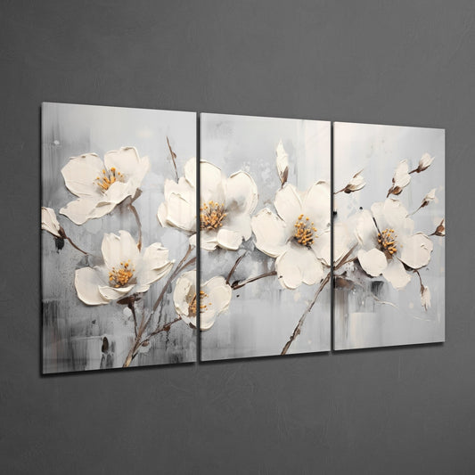 White blossom branches 3-panel glass wall art set on a dark gray wall, glossy glass panels side by side