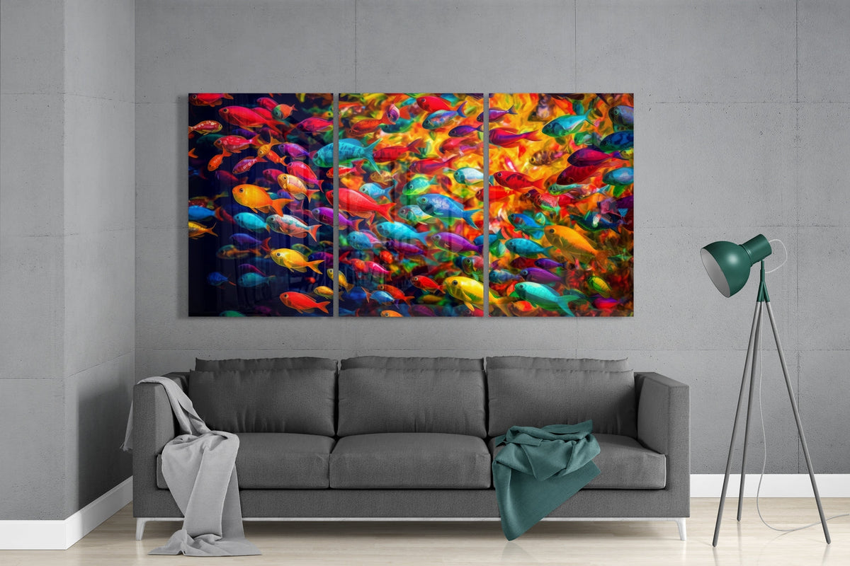 Rainbow fish school 3-panel glass wall art above a gray sofa beside a green floor lamp