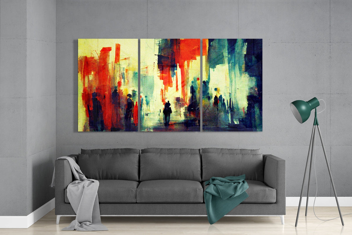 Red and teal street silhouettes glass wall art set above a gray sofa beside a tripod floor lamp