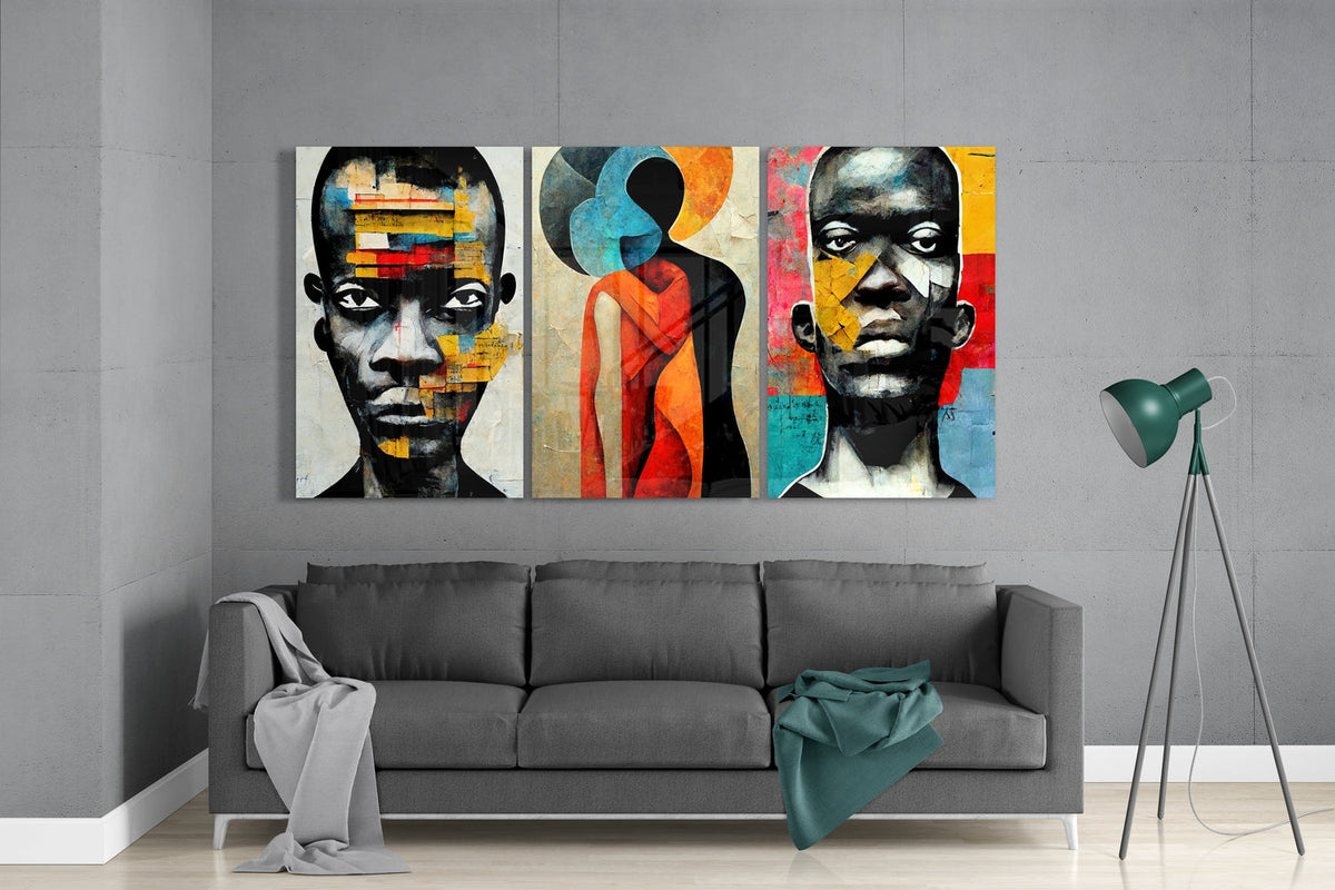 Collage portrait faces glass wall art set above a gray sofa beside a tripod floor lamp