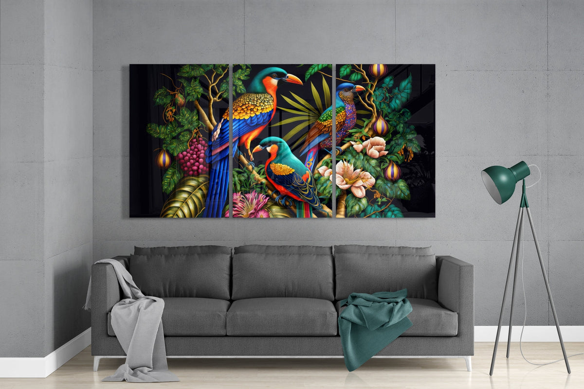 Tropical birds and flowers 3-panel glass wall art set above a gray sofa beside a tripod floor lamp