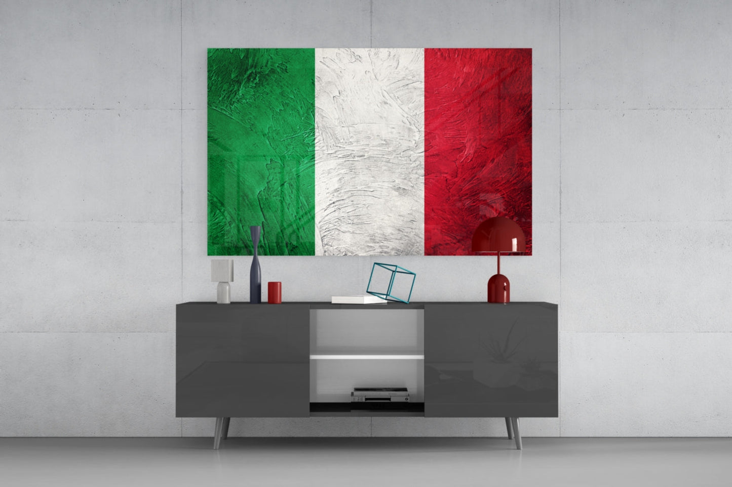Weathered Italy flag glass wall art above a dark gray sideboard against a pale concrete wall