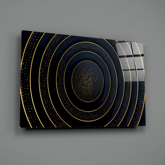 Gold concentric circles glass wall art on a gray wall with a window reflected in the glossy surface