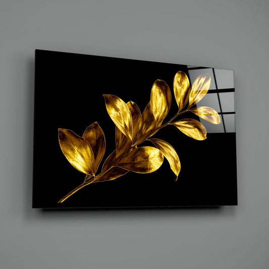 Gold leaf branch glass wall art on a gray wall with a window reflected in the glossy surface