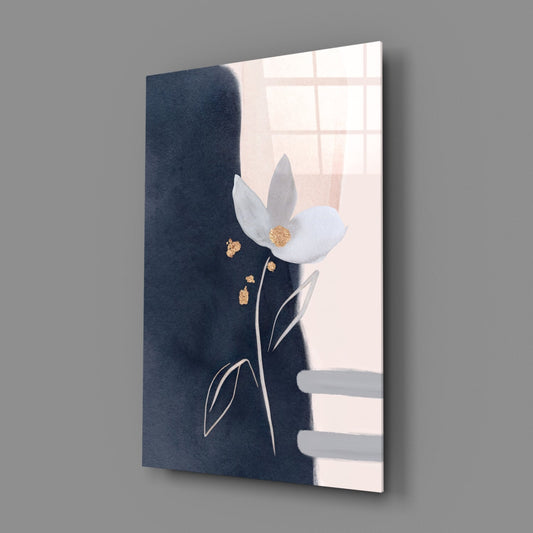 White flower on navy and blush vertical glass wall art on a gray wall with a window reflected in the glossy surface