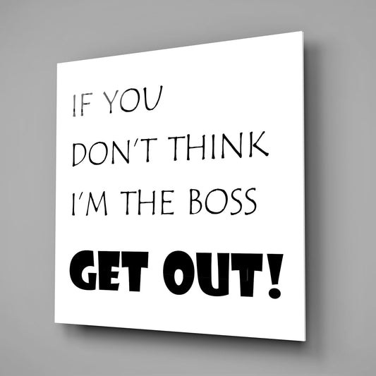 Funny boss quote in black text on white square glass wall art on a gray wall with a soft shadow