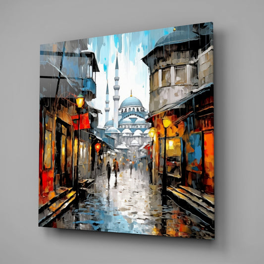 Rainy street and mosque glass wall art hanging on a plain gray wall, seen at an angle