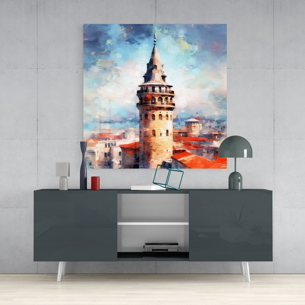 Galata Tower and rooftops glass wall art above a dark gray sideboard with a dome lamp and vase